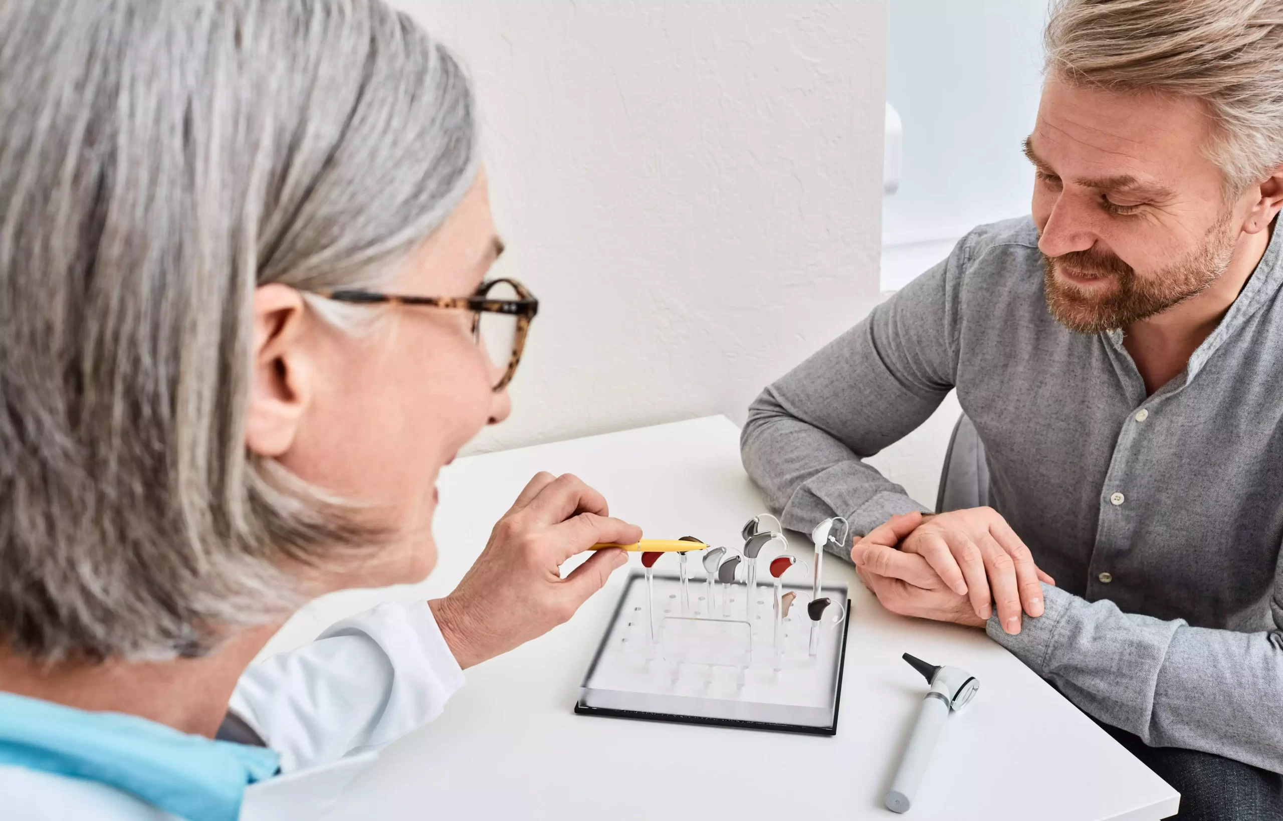 a woman in the middle of a consultation laughing with her doctor